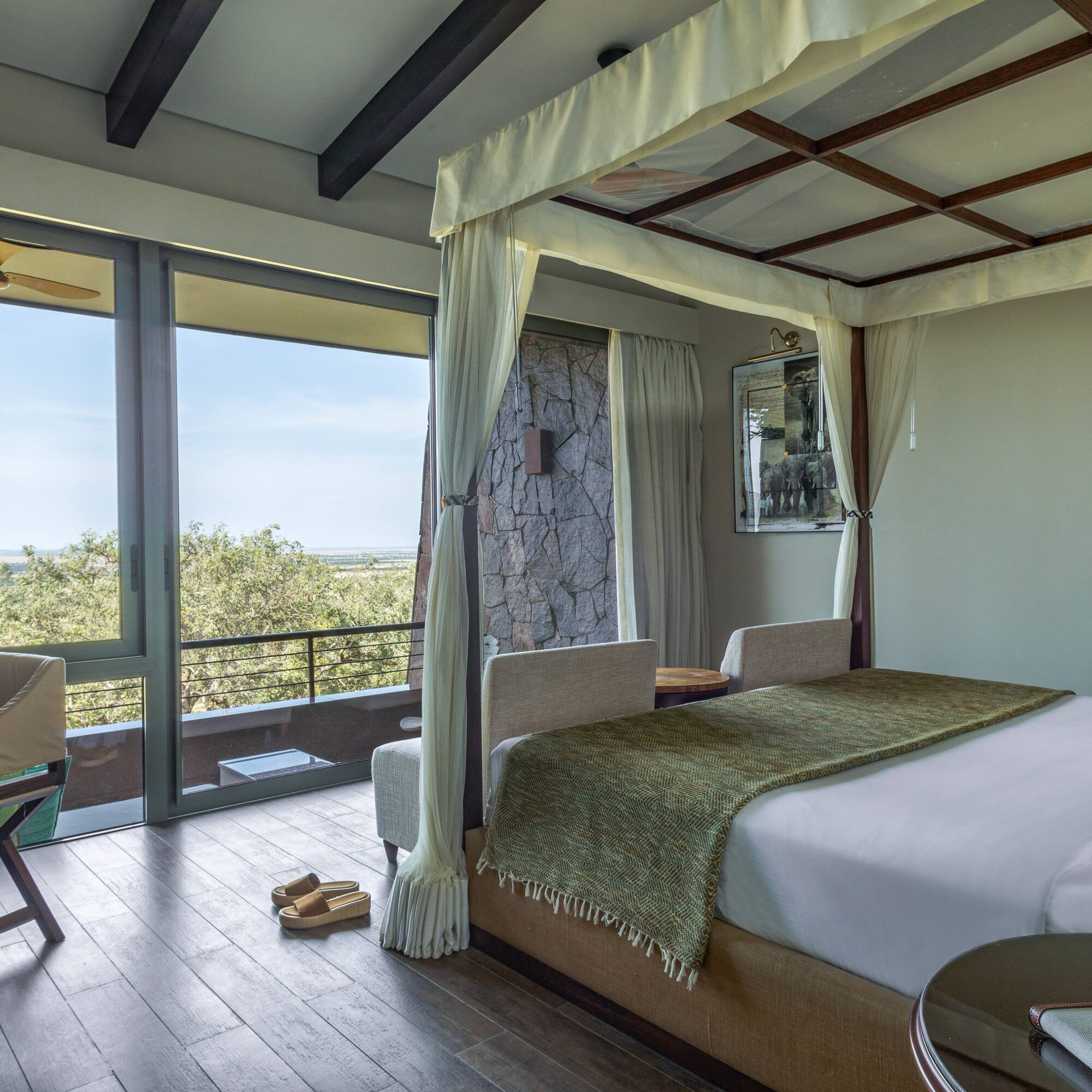 a bedroom with a canopy bed and a chair