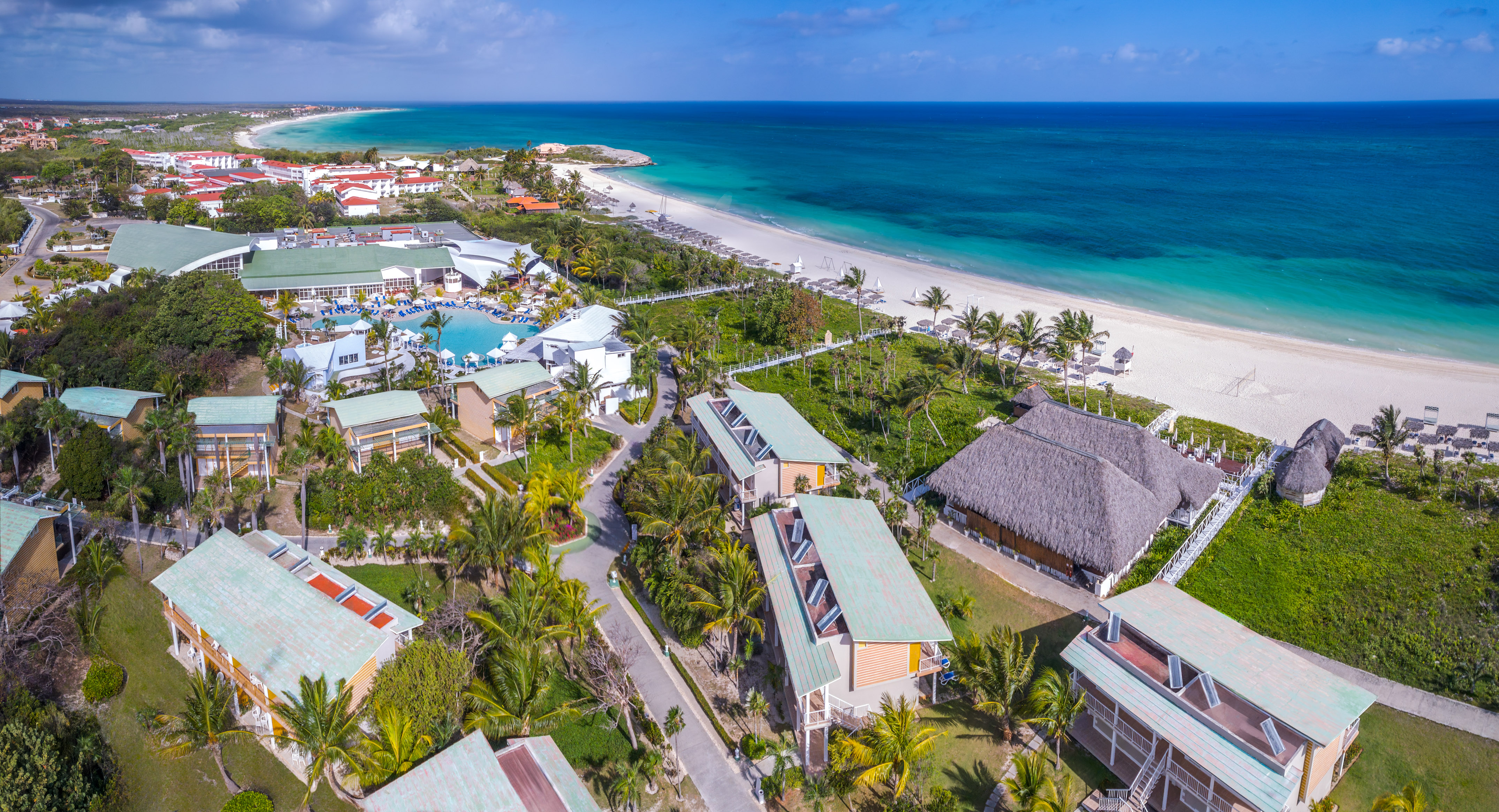 a beach with houses and a body of water