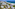 a beach with houses and a body of water