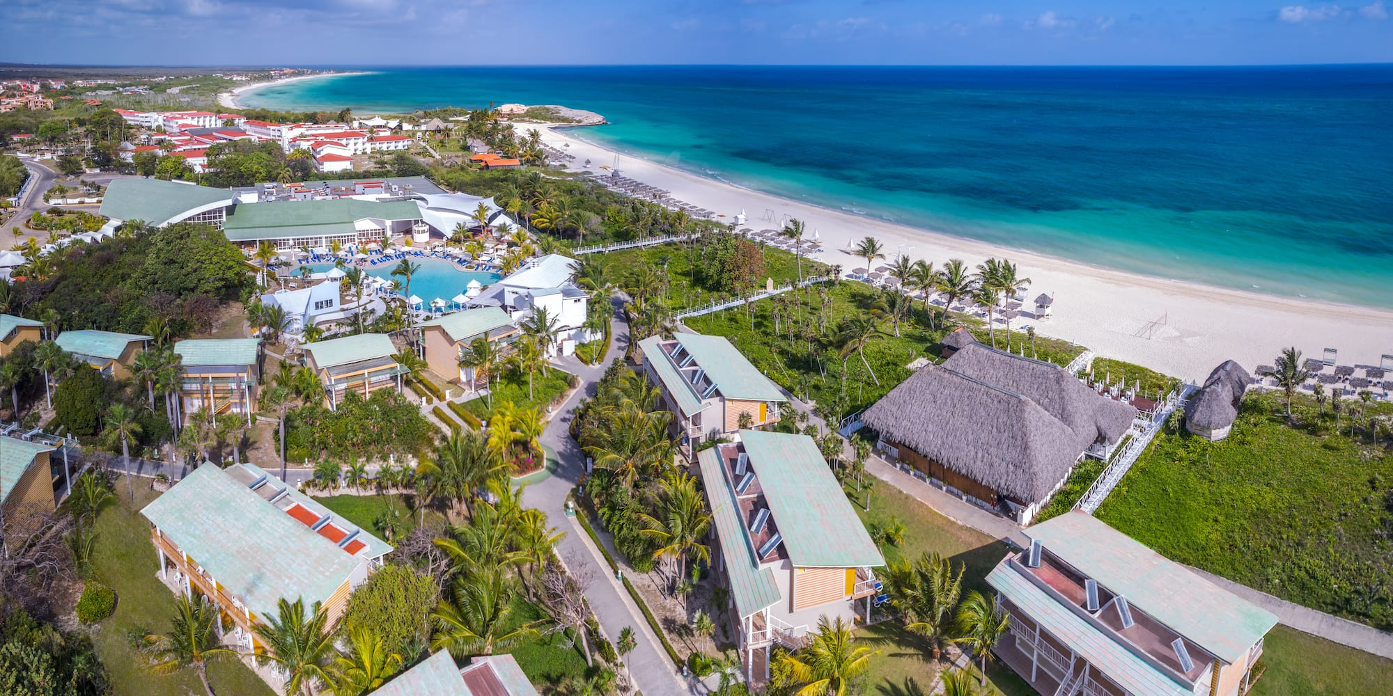 a beach with houses and a body of water