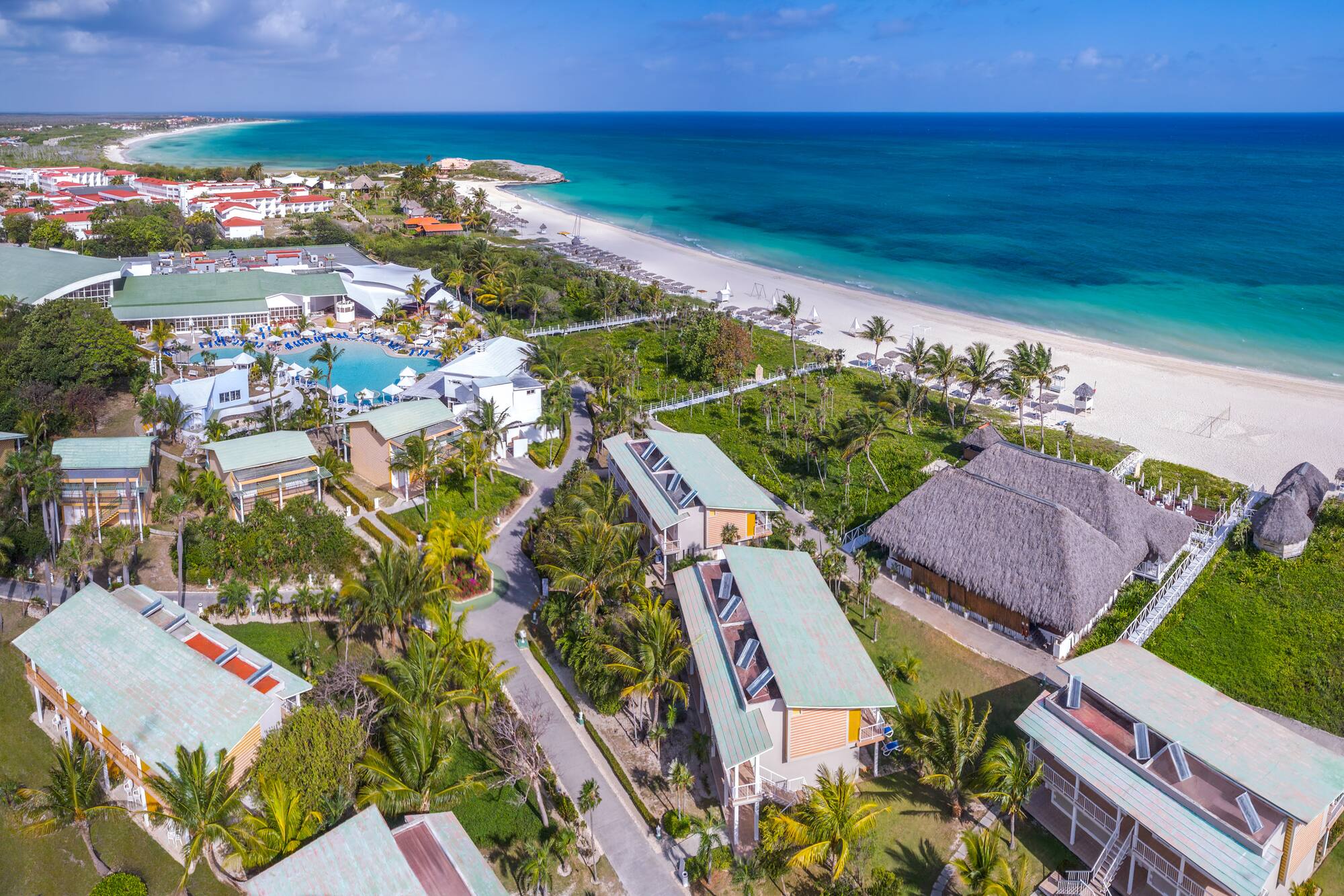 a beach with houses and a body of water