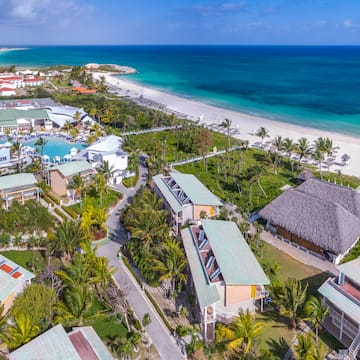 a beach with houses and a body of water