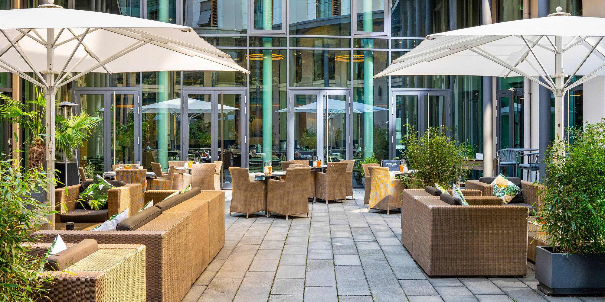 a patio area with chairs and umbrellas