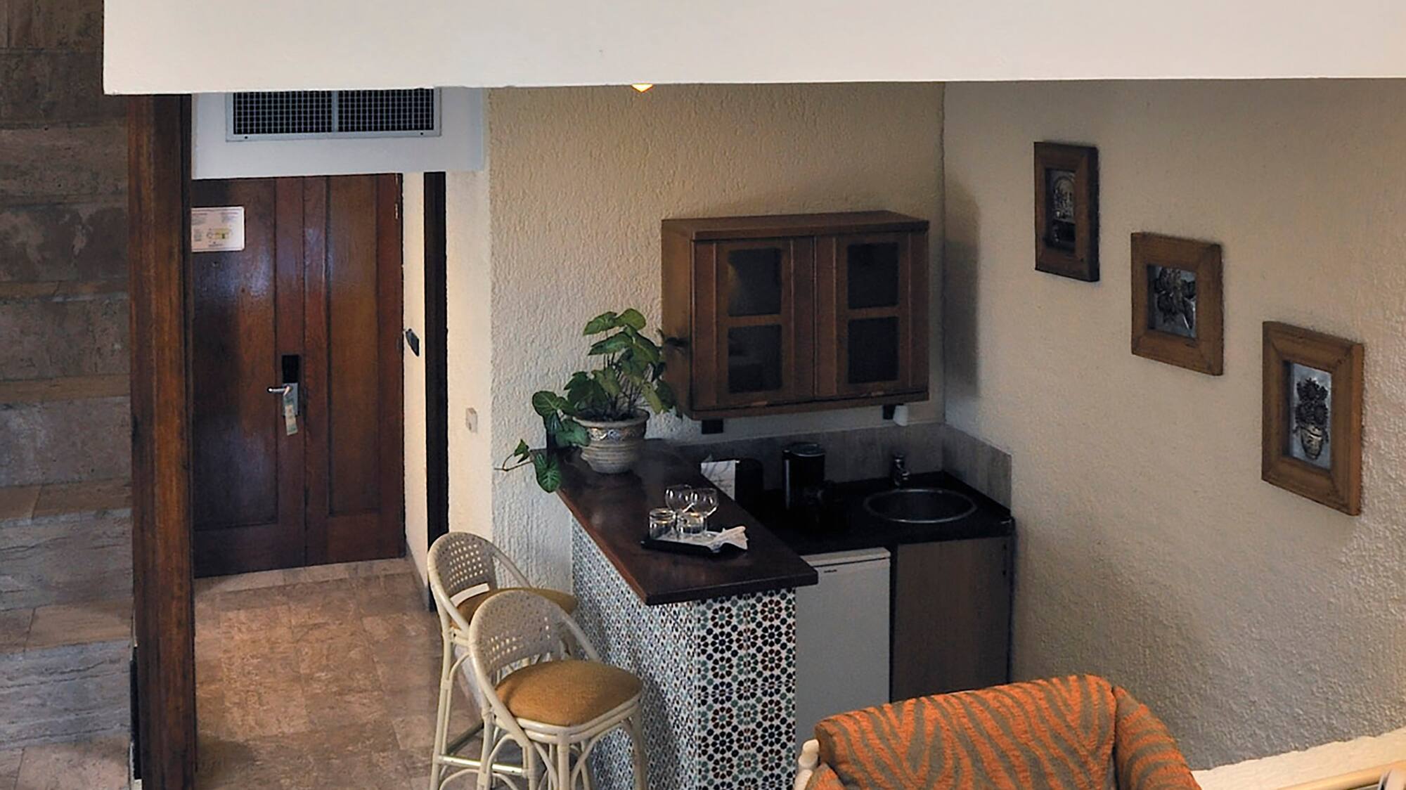 a room with a small kitchen and a small dining area