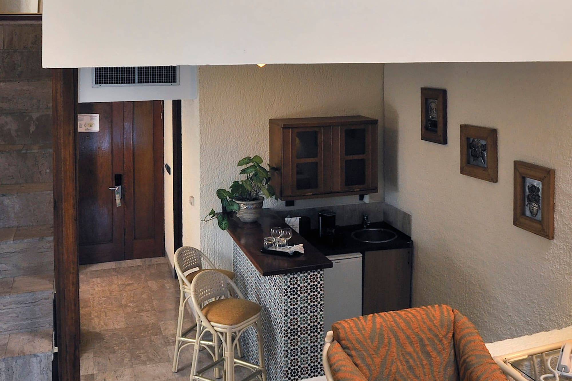 a room with a small kitchen and a small dining area