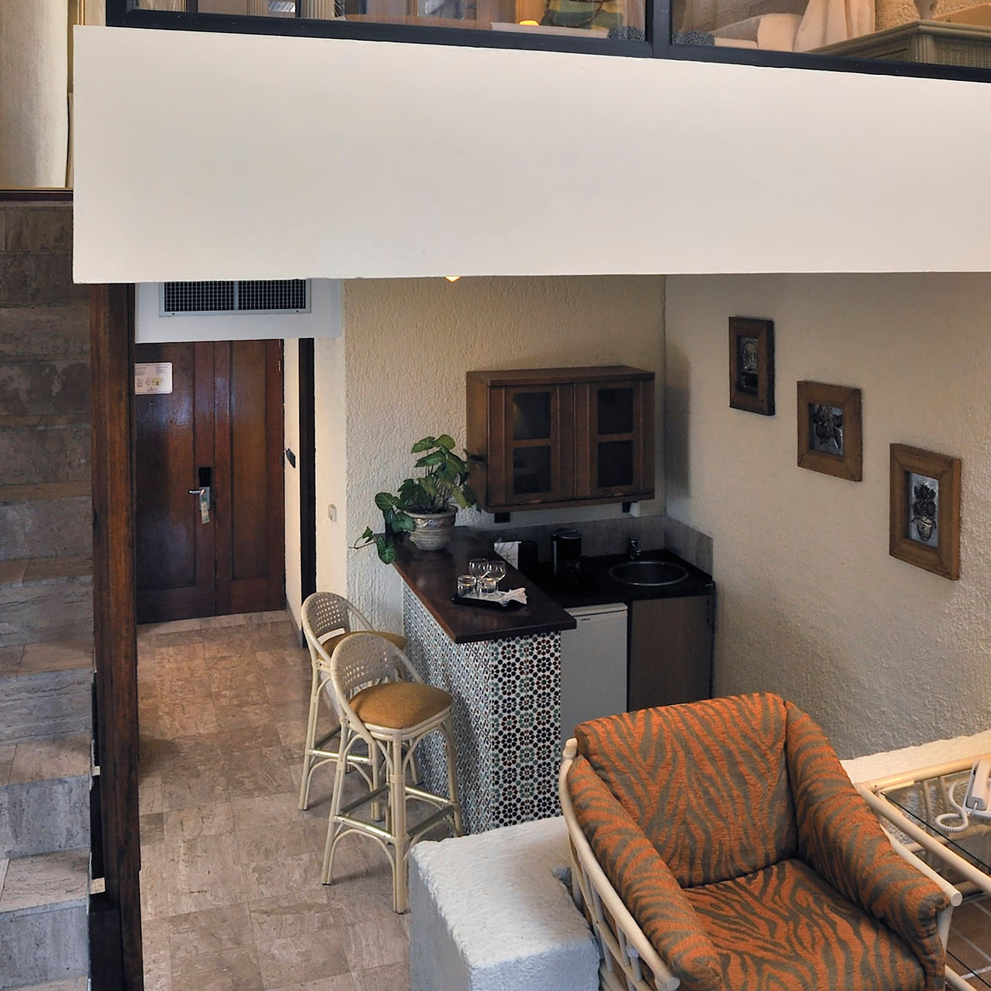 a room with a small kitchen and a small dining area