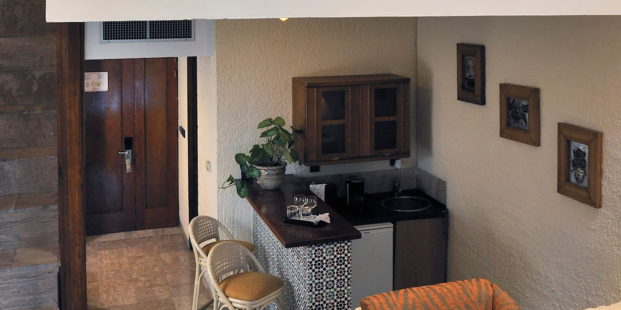 a room with a small kitchen and a small dining area