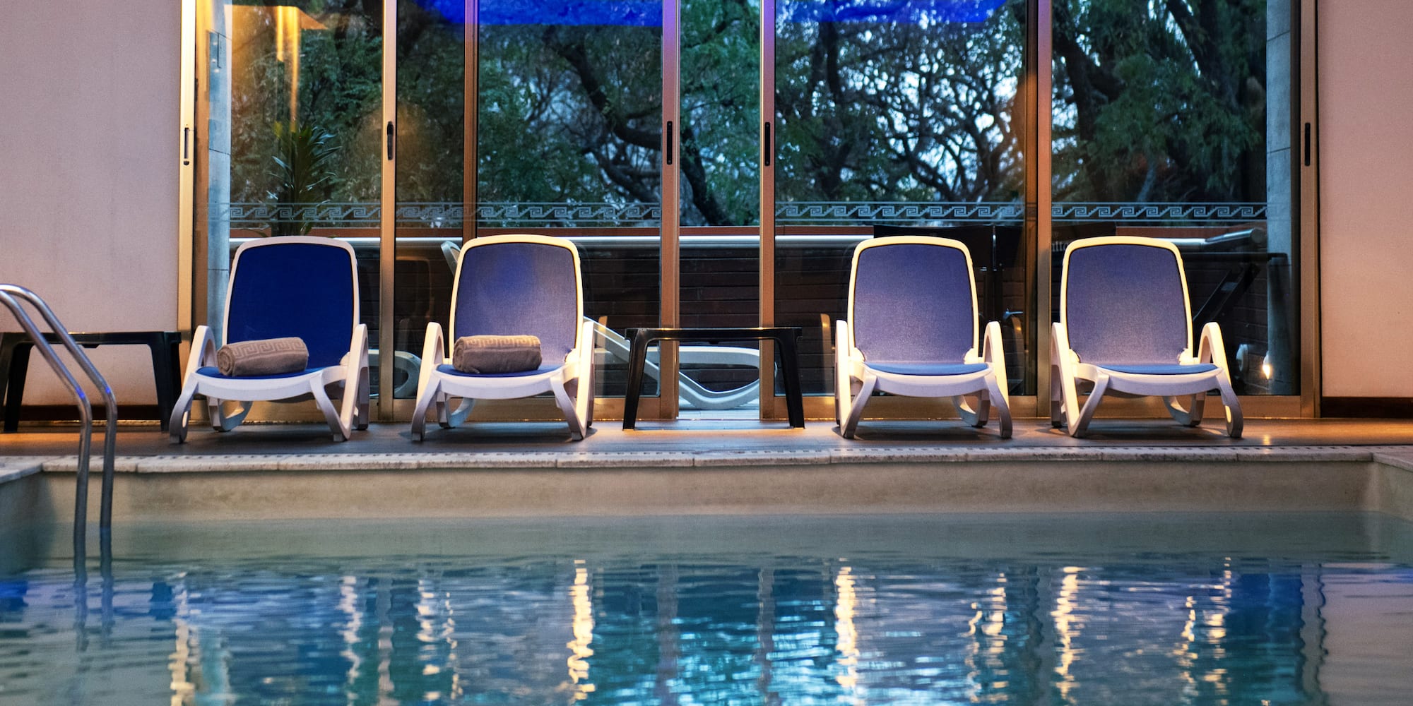 a pool with chairs and a table