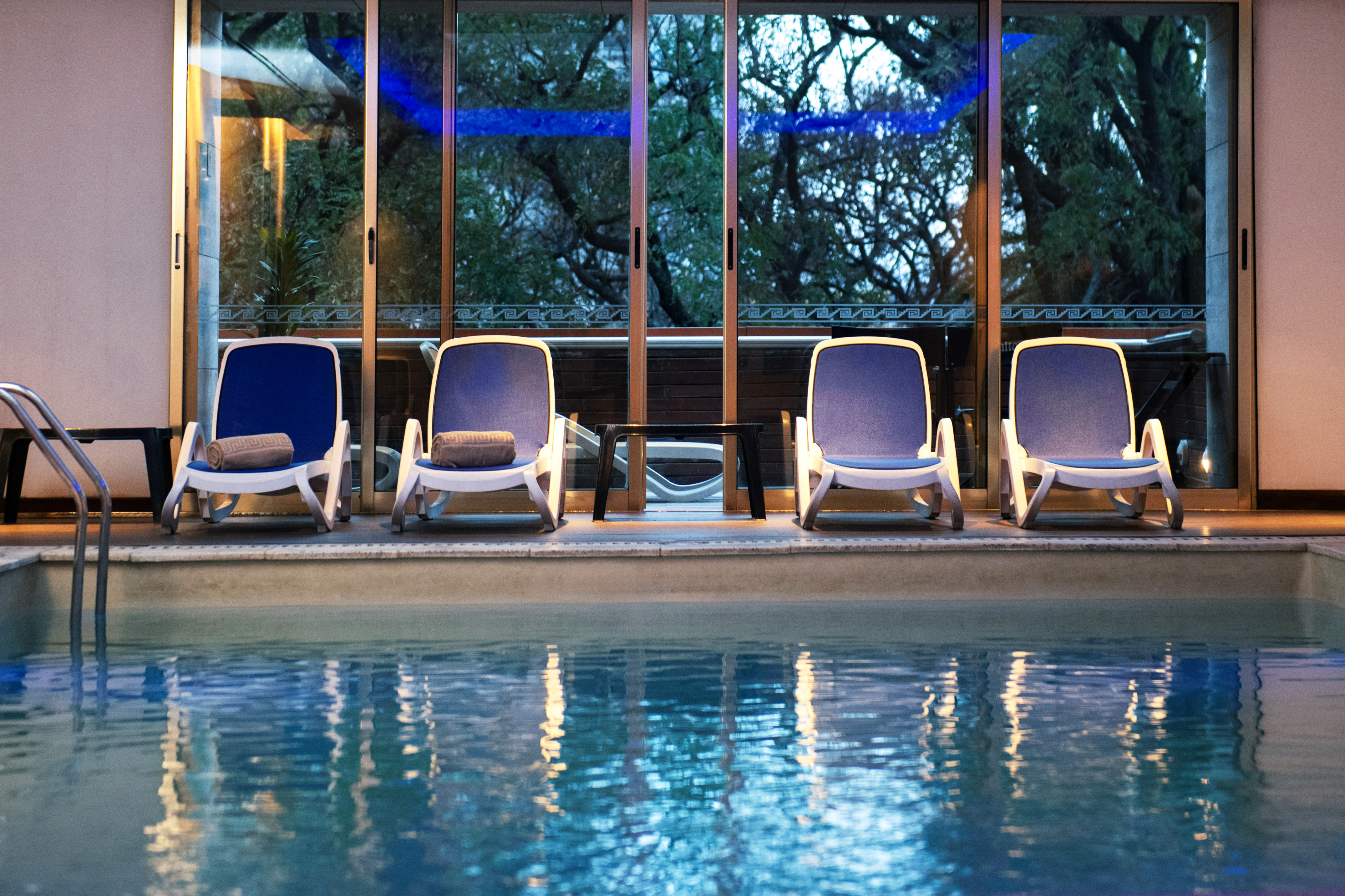 a pool with chairs and a table