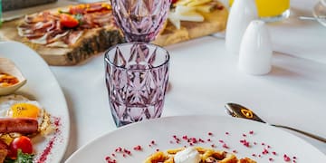 a table with plates of food and glasses