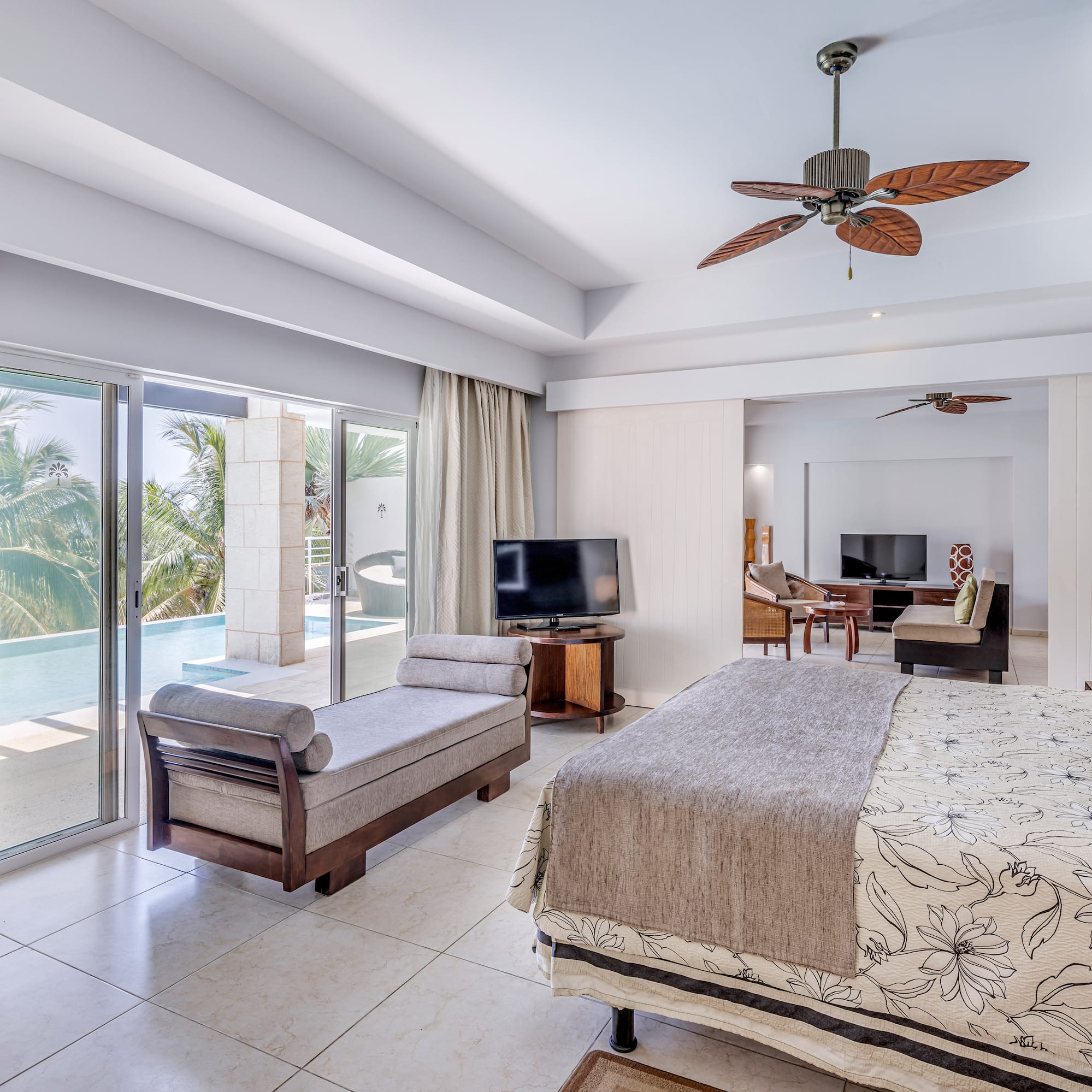 a bedroom with a bed and a television and a pool