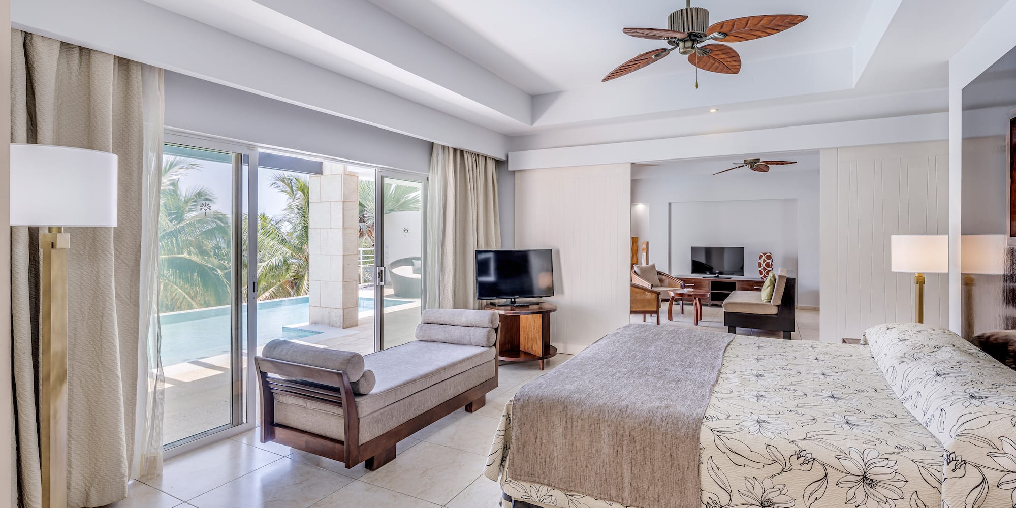 a bedroom with a bed and a television and a pool