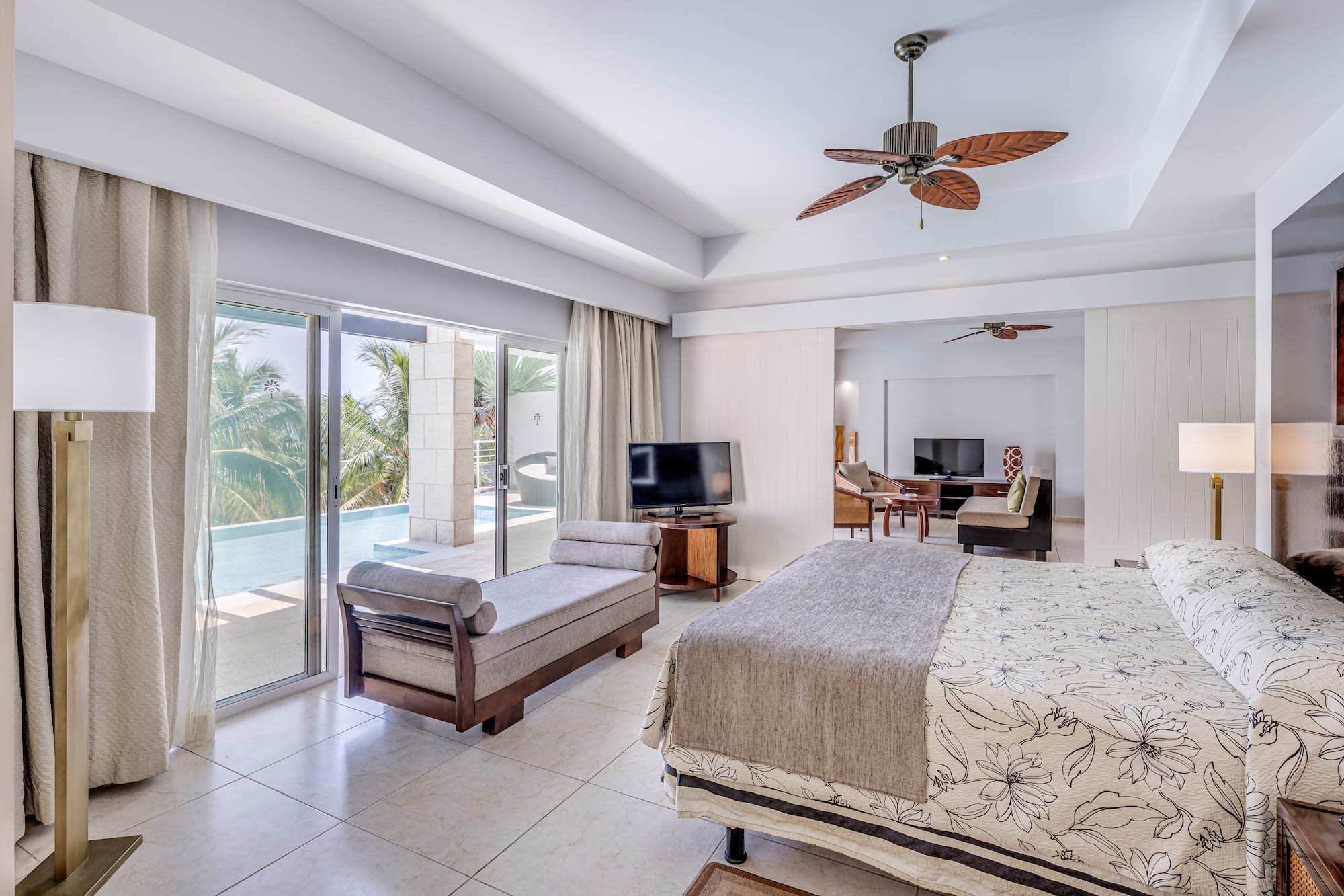a bedroom with a bed and a television and a pool