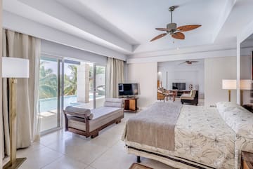 a bedroom with a bed and a television and a pool