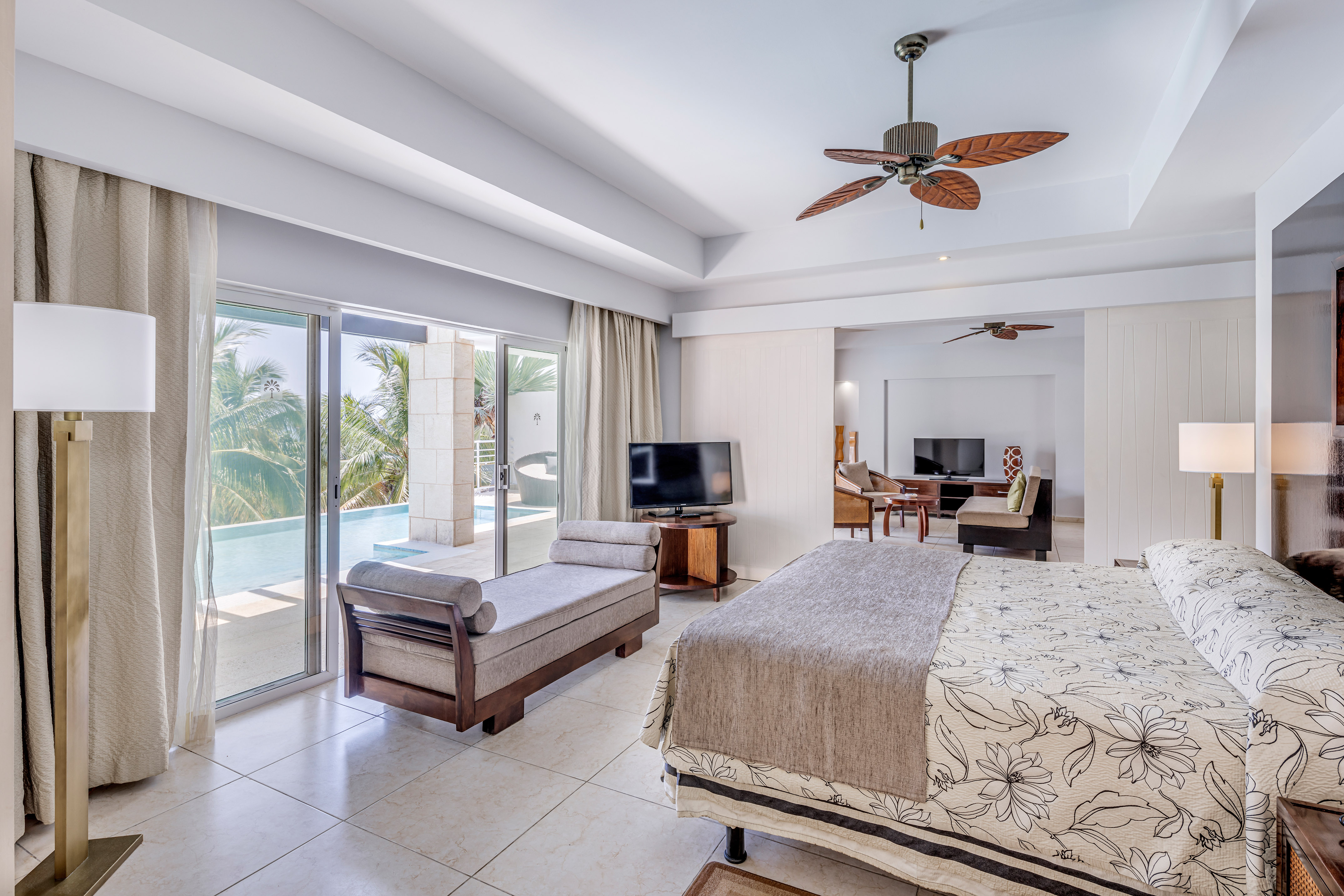 a bedroom with a bed and a television and a pool