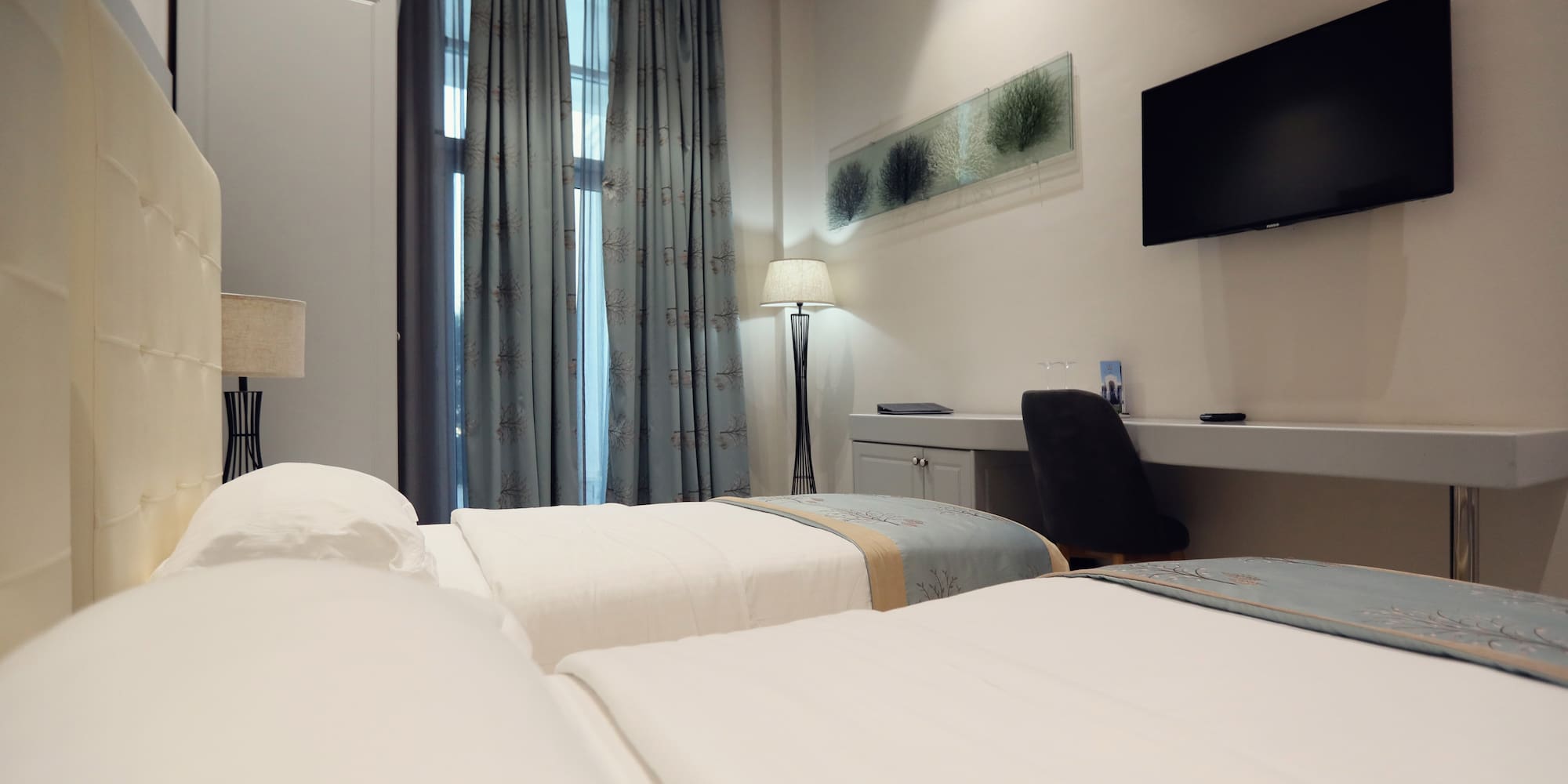 a room with two beds and a tv