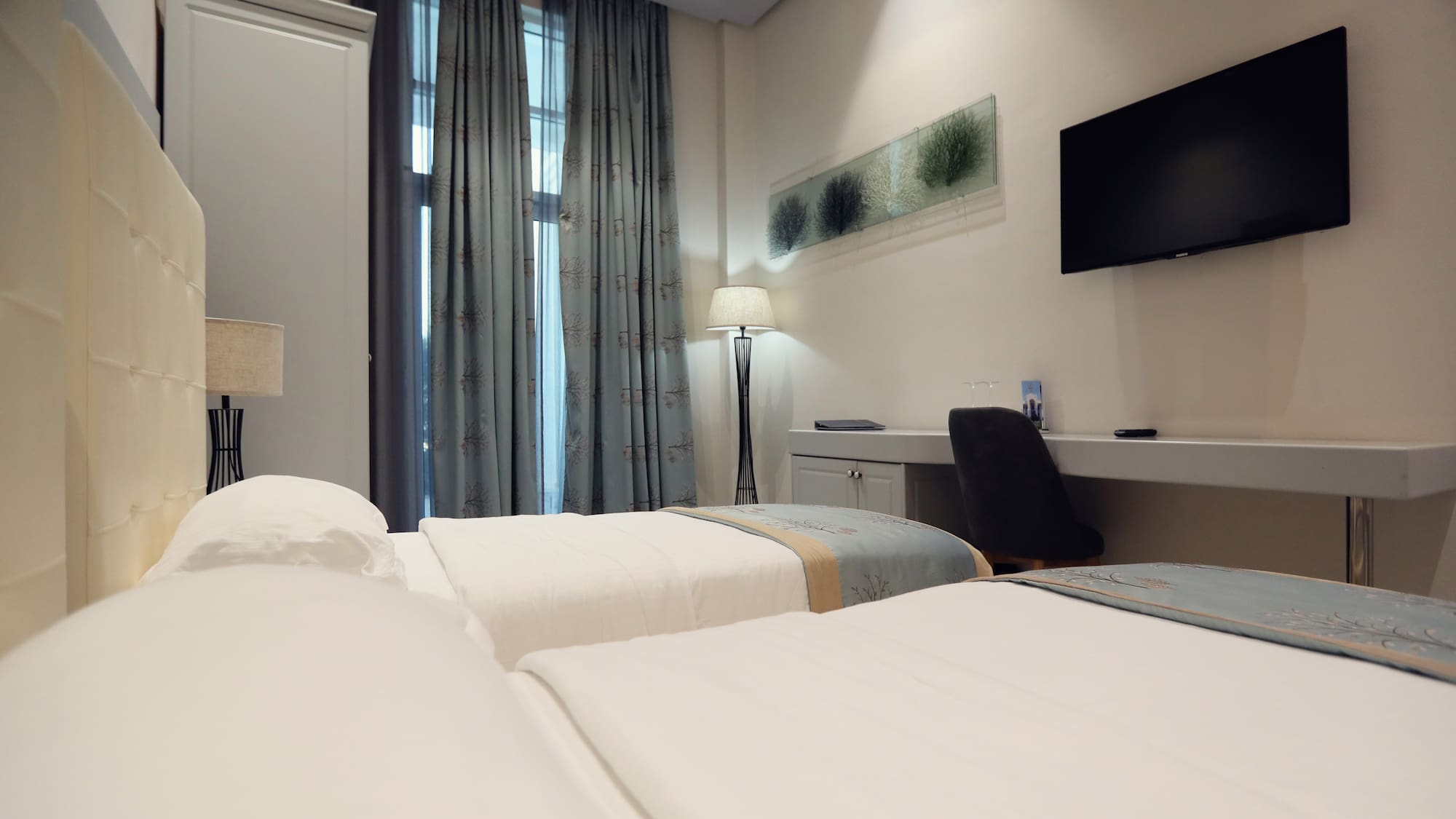 a room with two beds and a tv