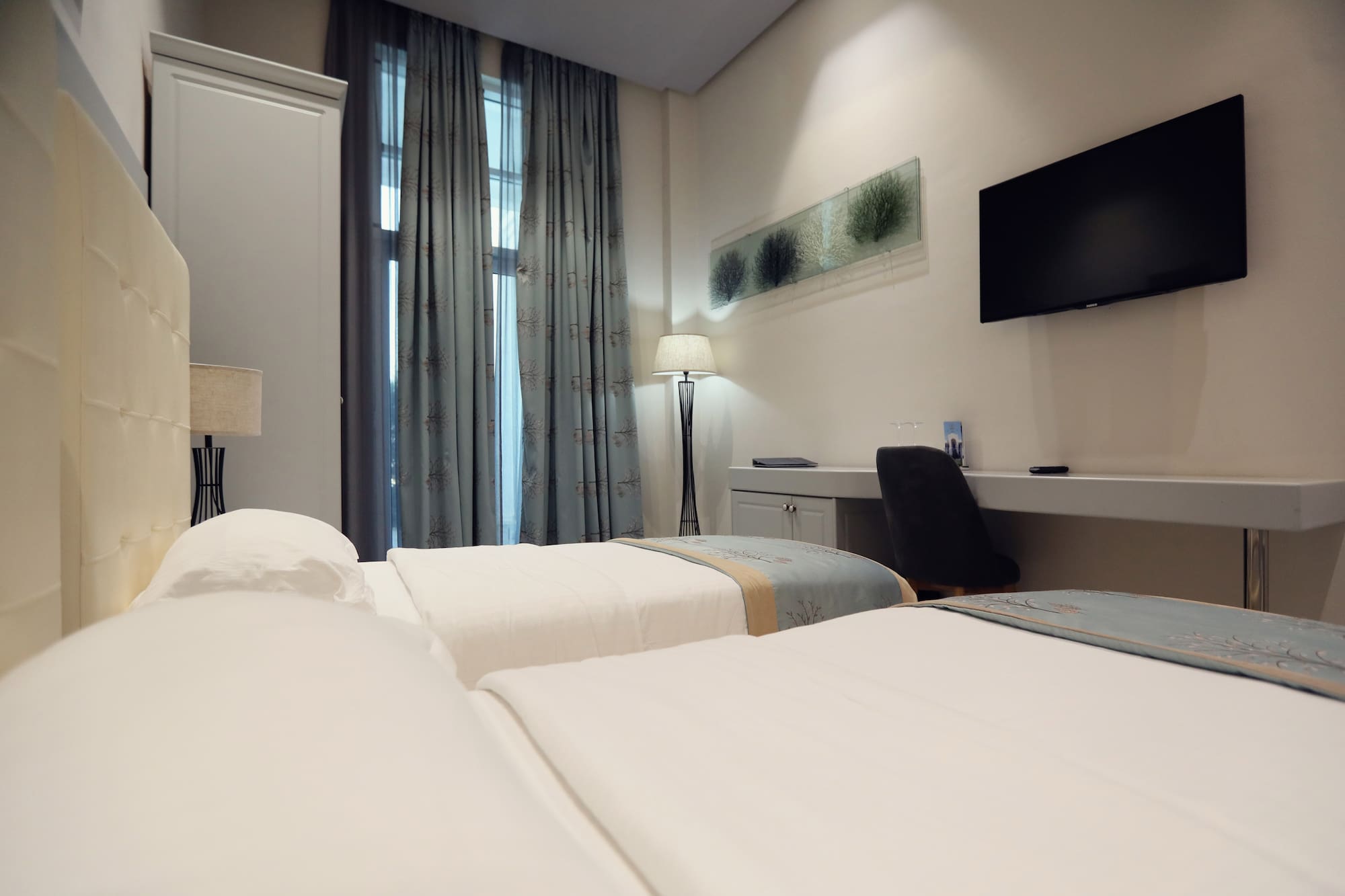 a room with two beds and a tv