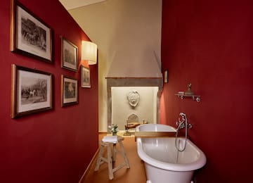 a bathroom with a tub and a stool