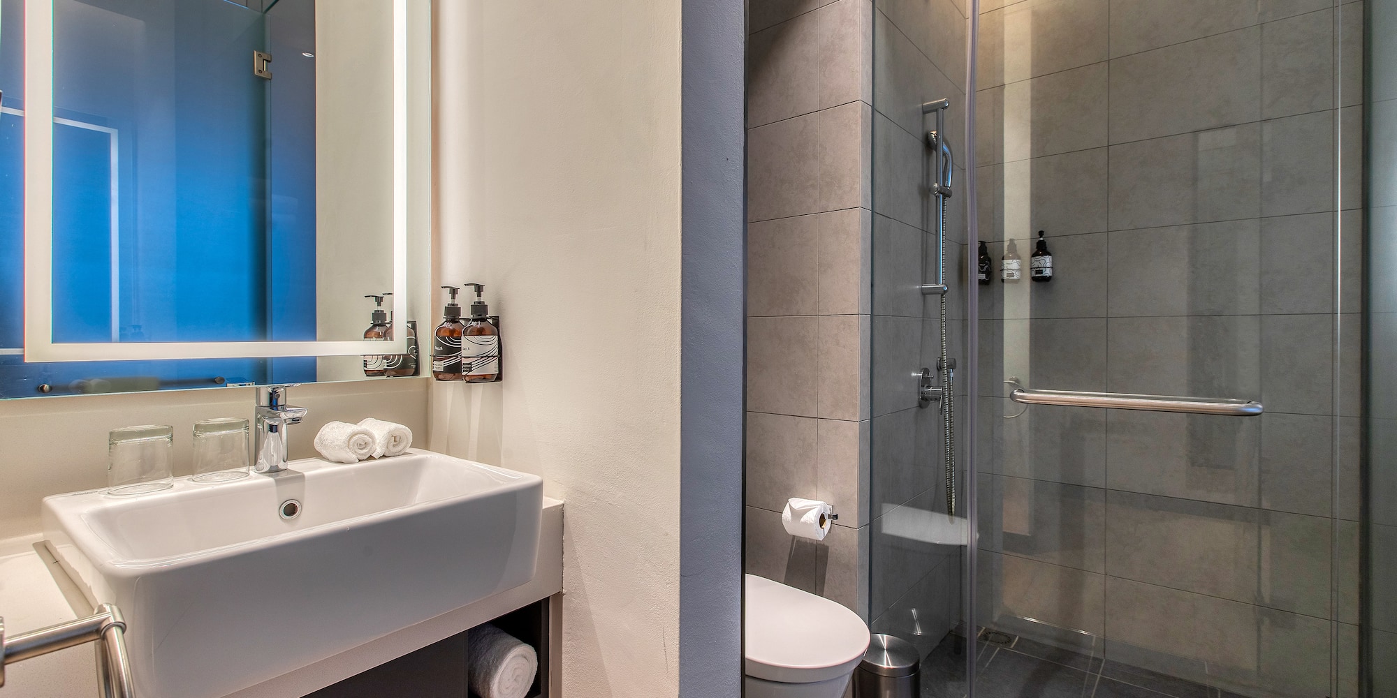 a bathroom with a shower and sink