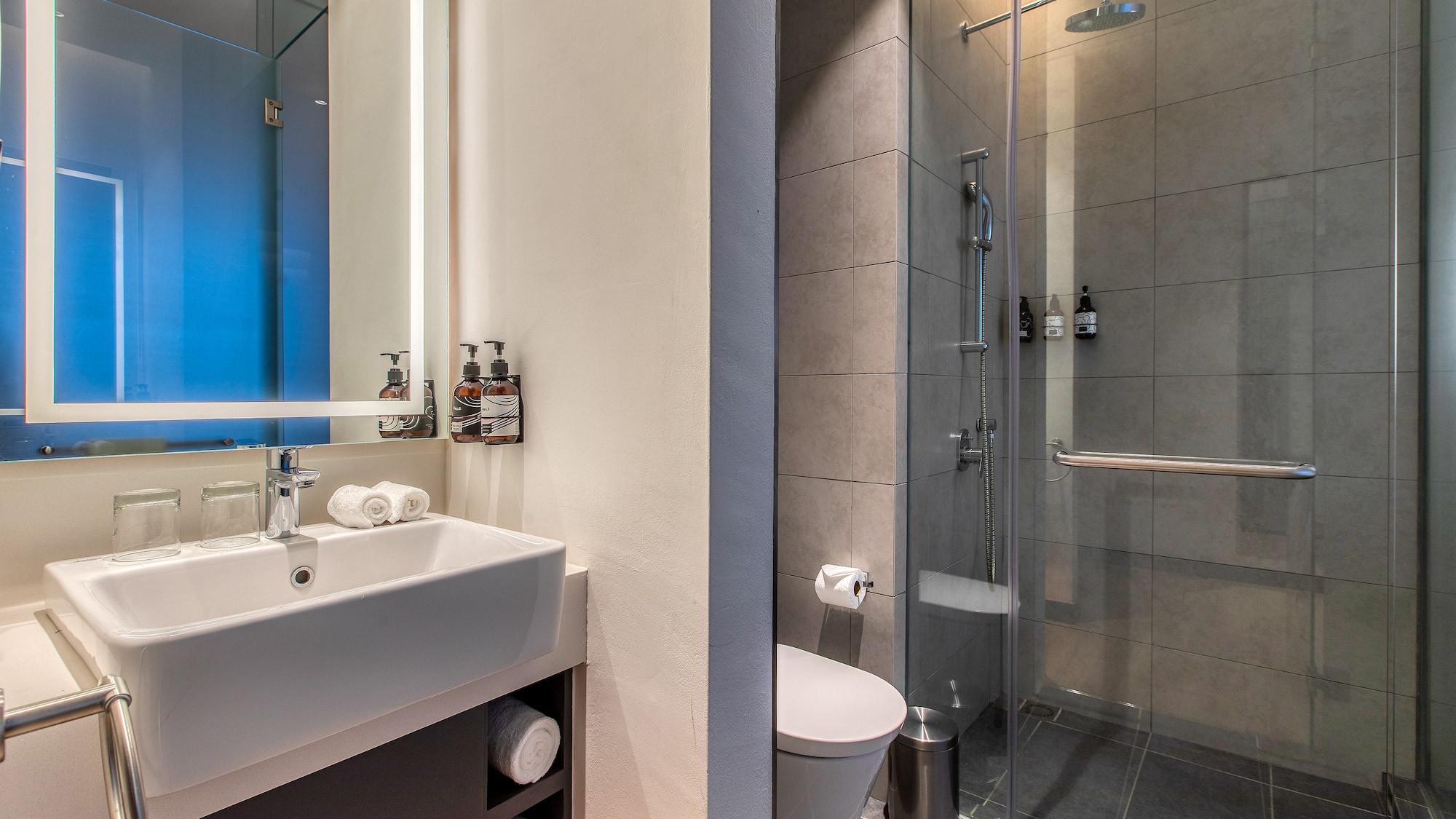 a bathroom with a shower and sink