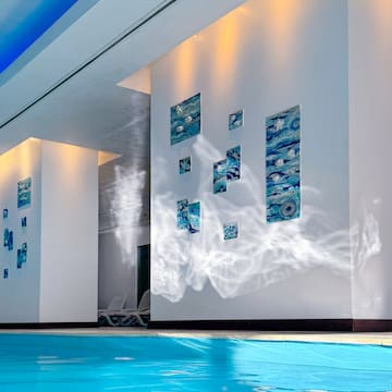 a swimming pool with art on the wall