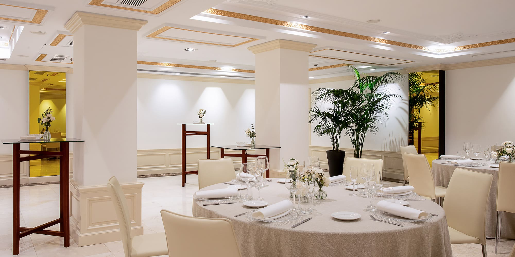 a room with a round table and chairs