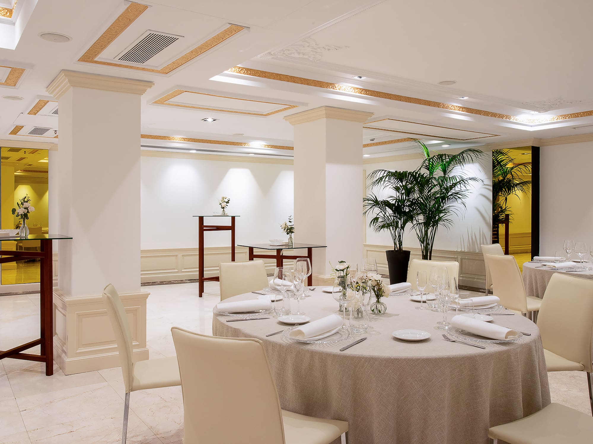 a room with a round table and chairs