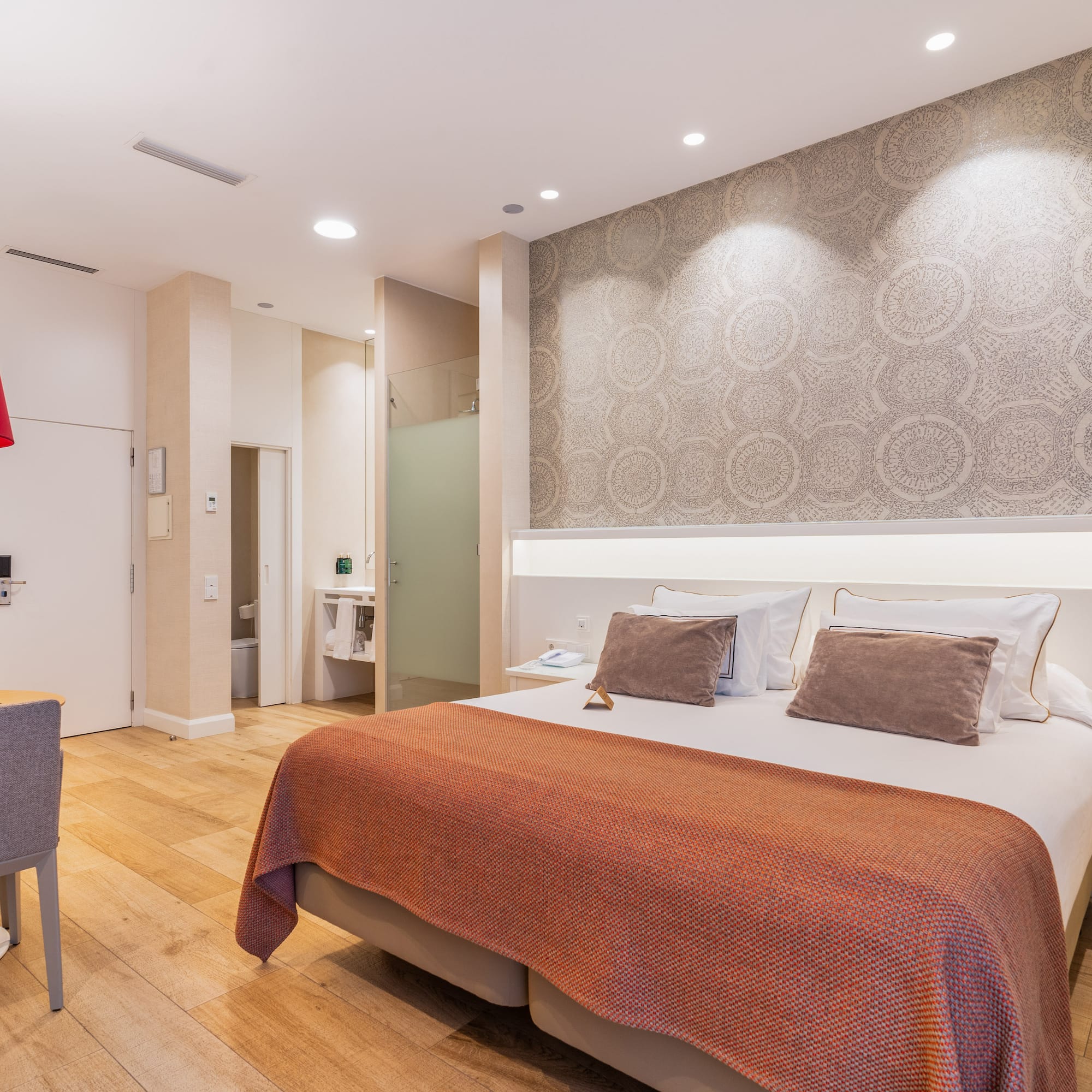 a bedroom with a bed and a chair