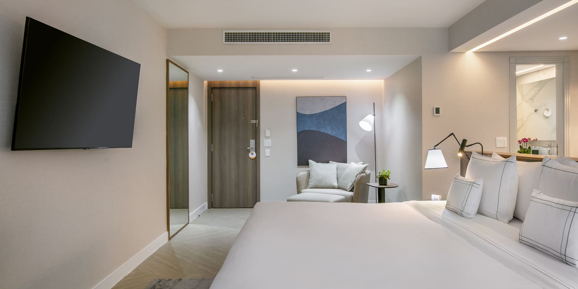 a bedroom with a bed and a television