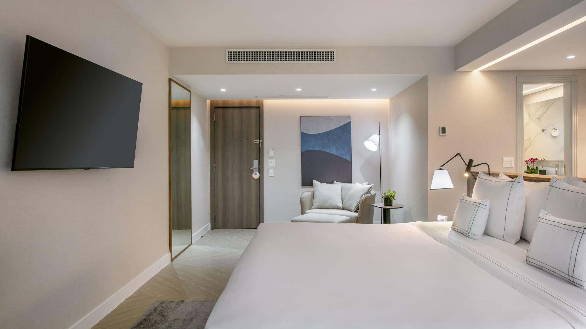 a bedroom with a bed and a television