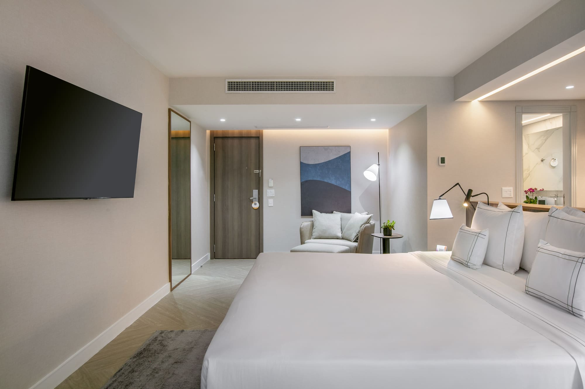 a bedroom with a bed and a television