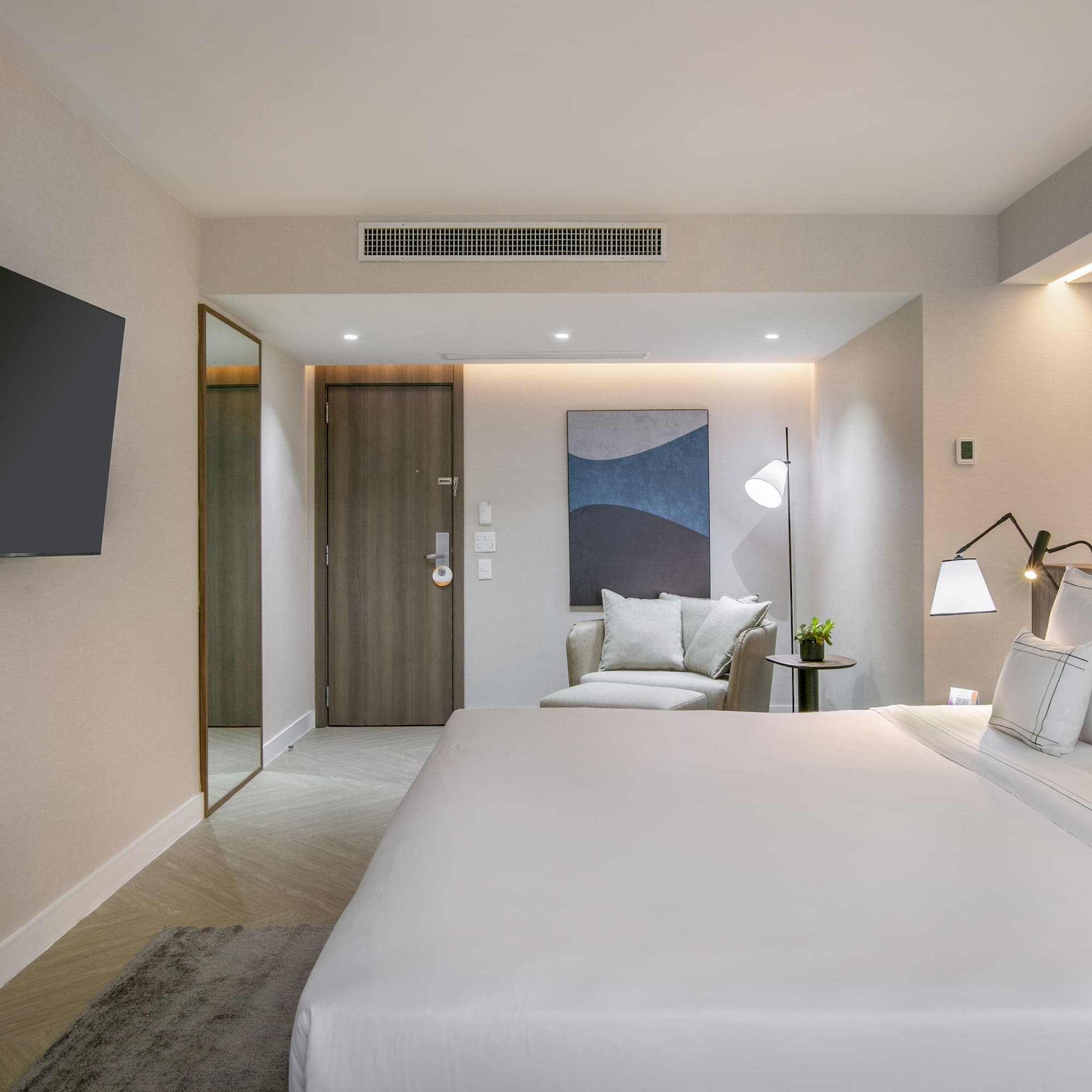 a bedroom with a bed and a television