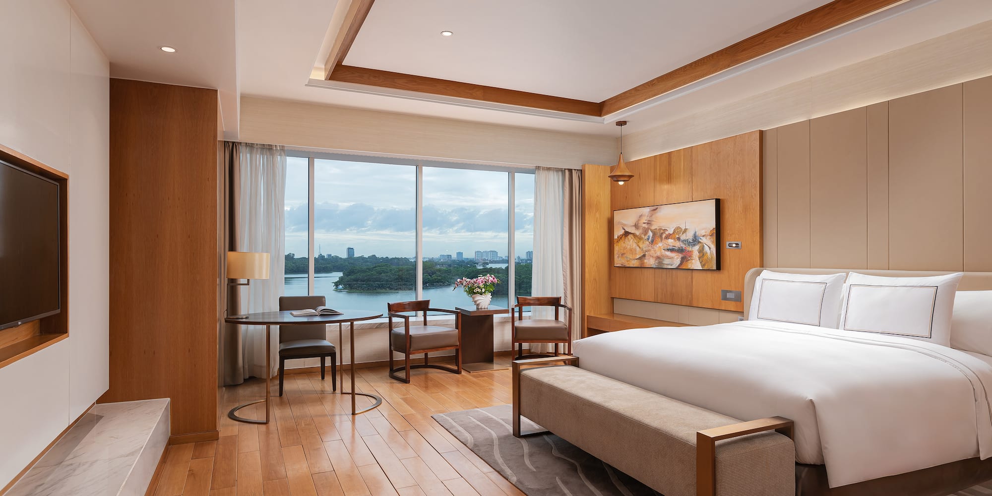 a room with a bed and a table and chairs