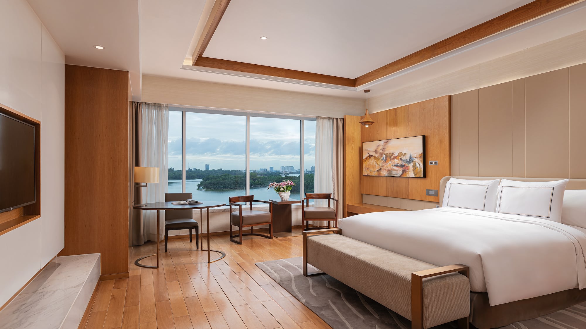 a room with a bed and a table and chairs