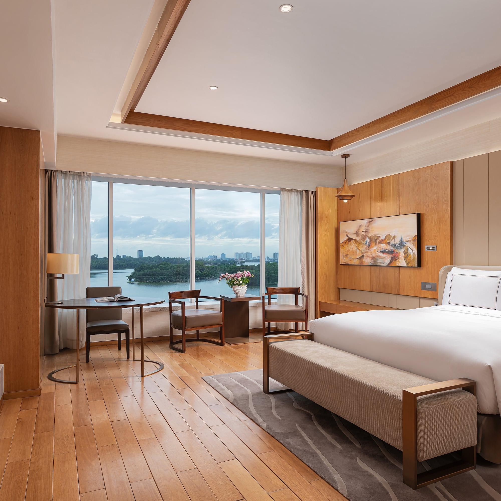 a room with a bed and a table and chairs