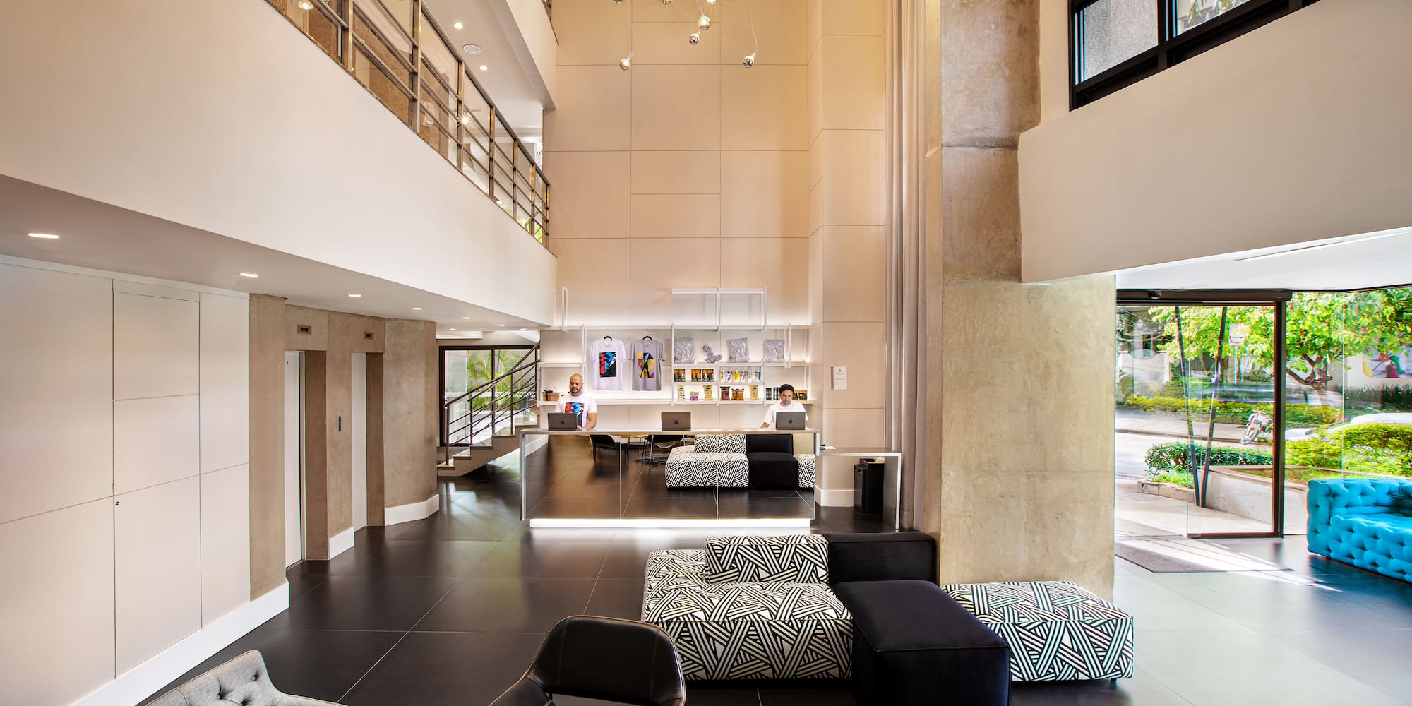a room with a large black floor and a black and white couch