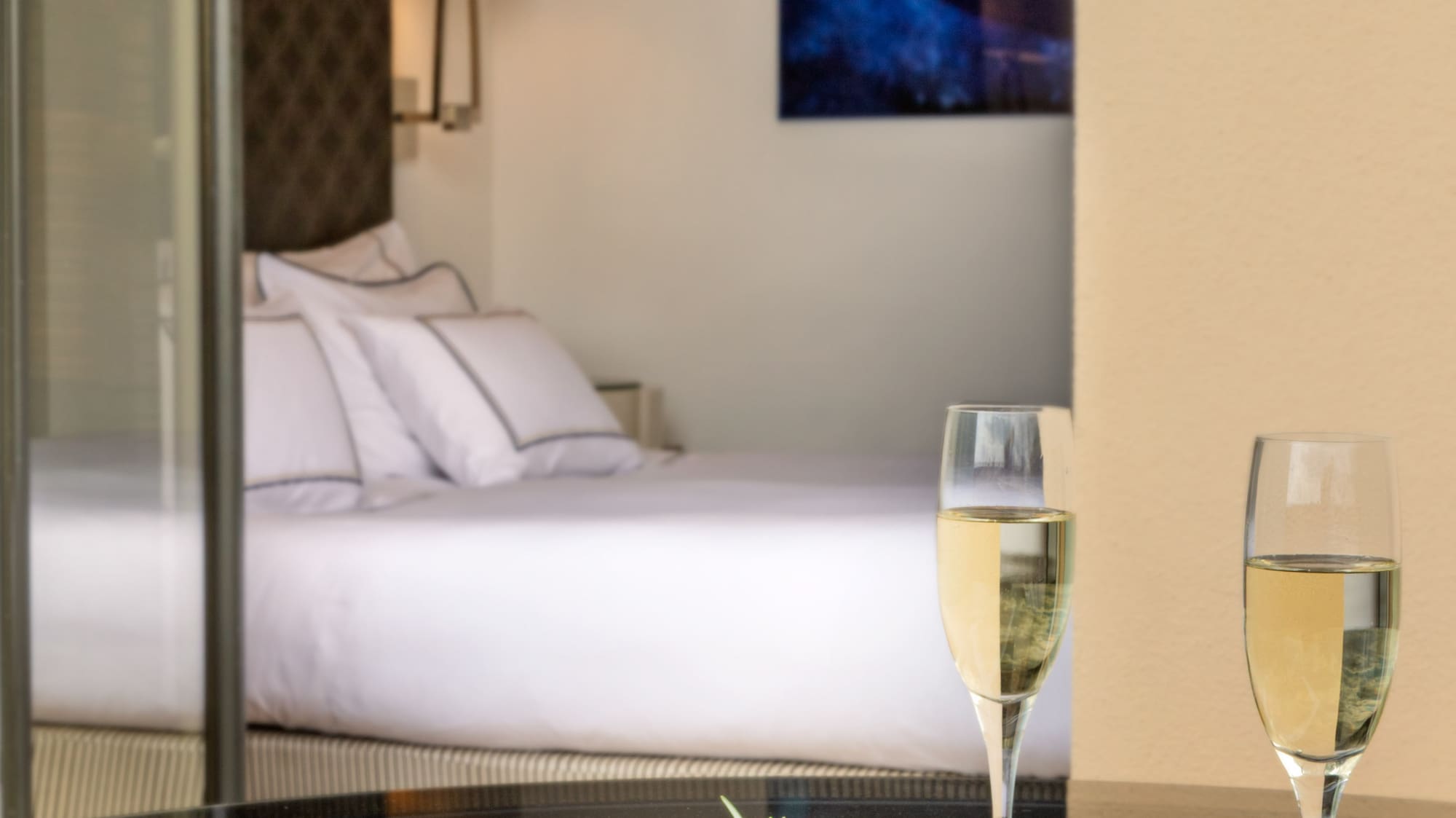 a plate of food and two glasses of champagne