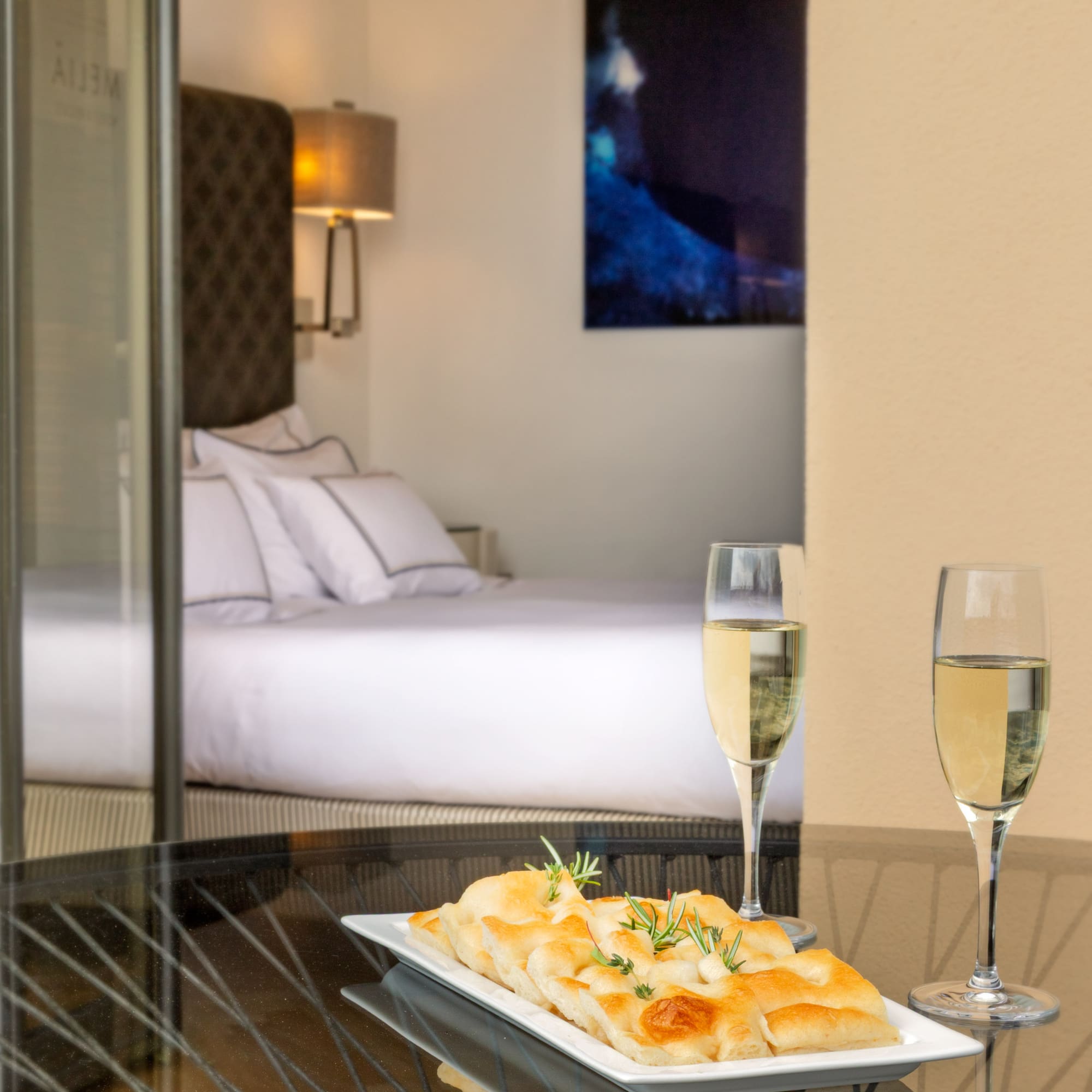 a plate of food and two glasses of champagne