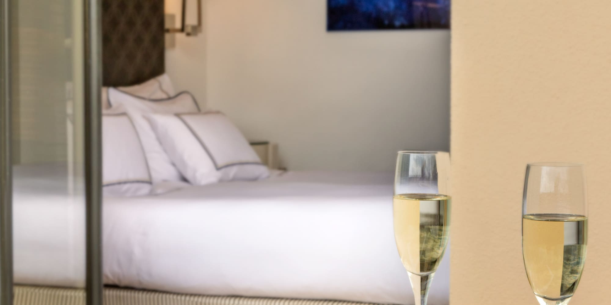 a plate of food and two glasses of champagne