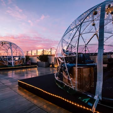 a clear dome with lights on top of it