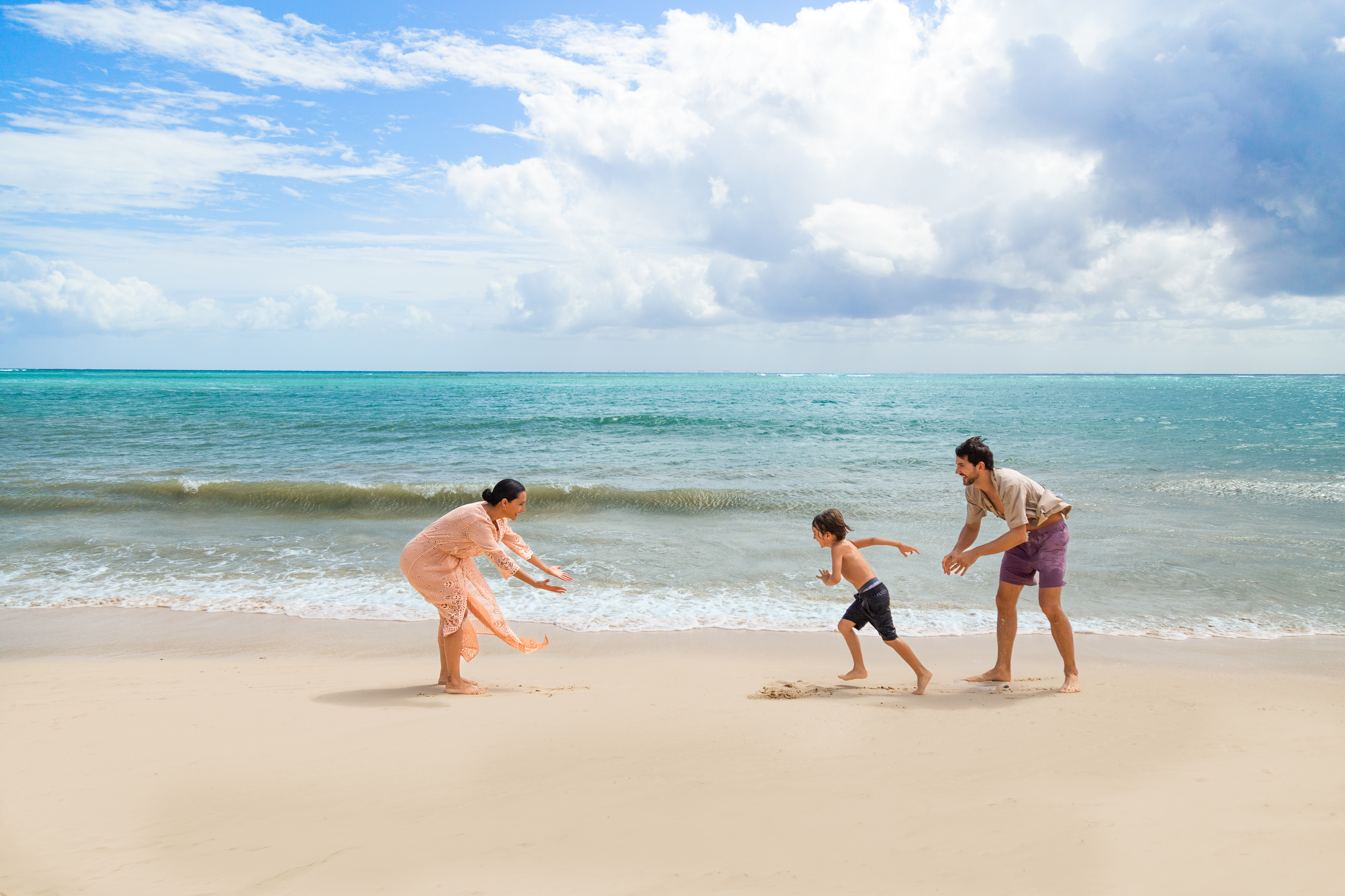 a group of people playing on a beach