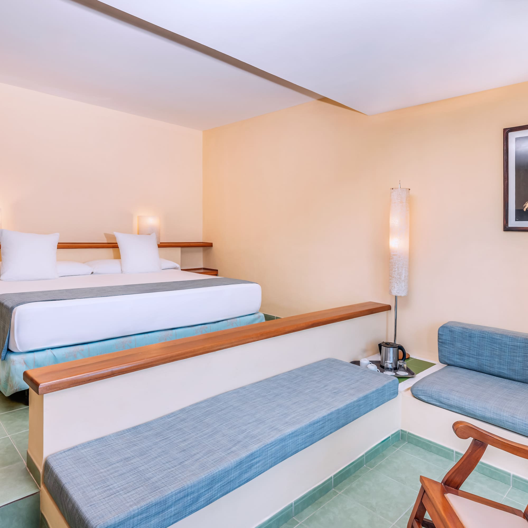 a room with two beds and a lamp