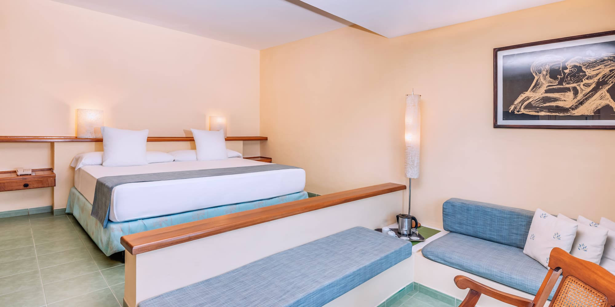 a room with two beds and a lamp