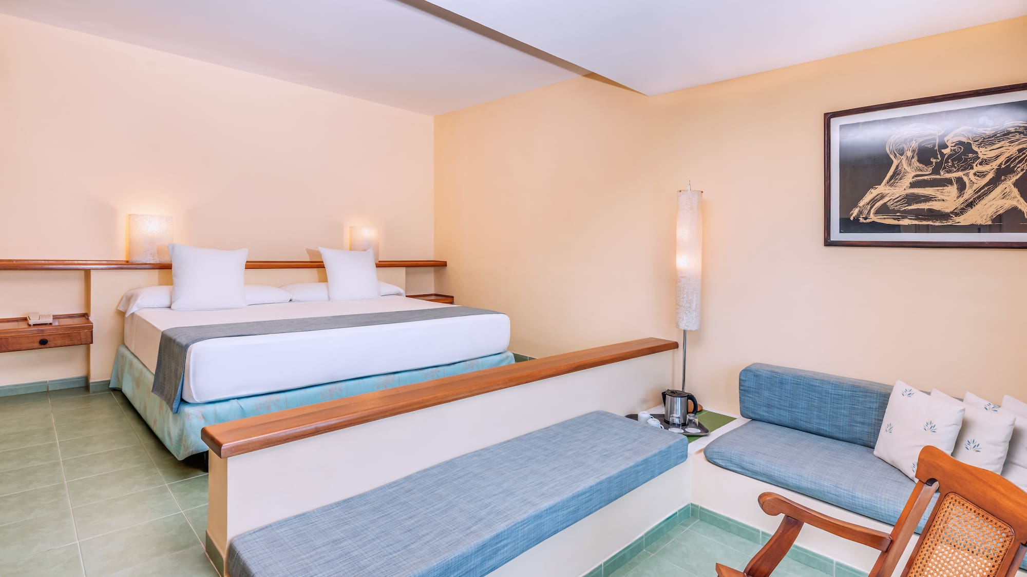 a room with two beds and a lamp