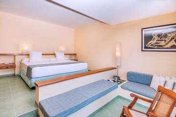 a room with two beds and a lamp