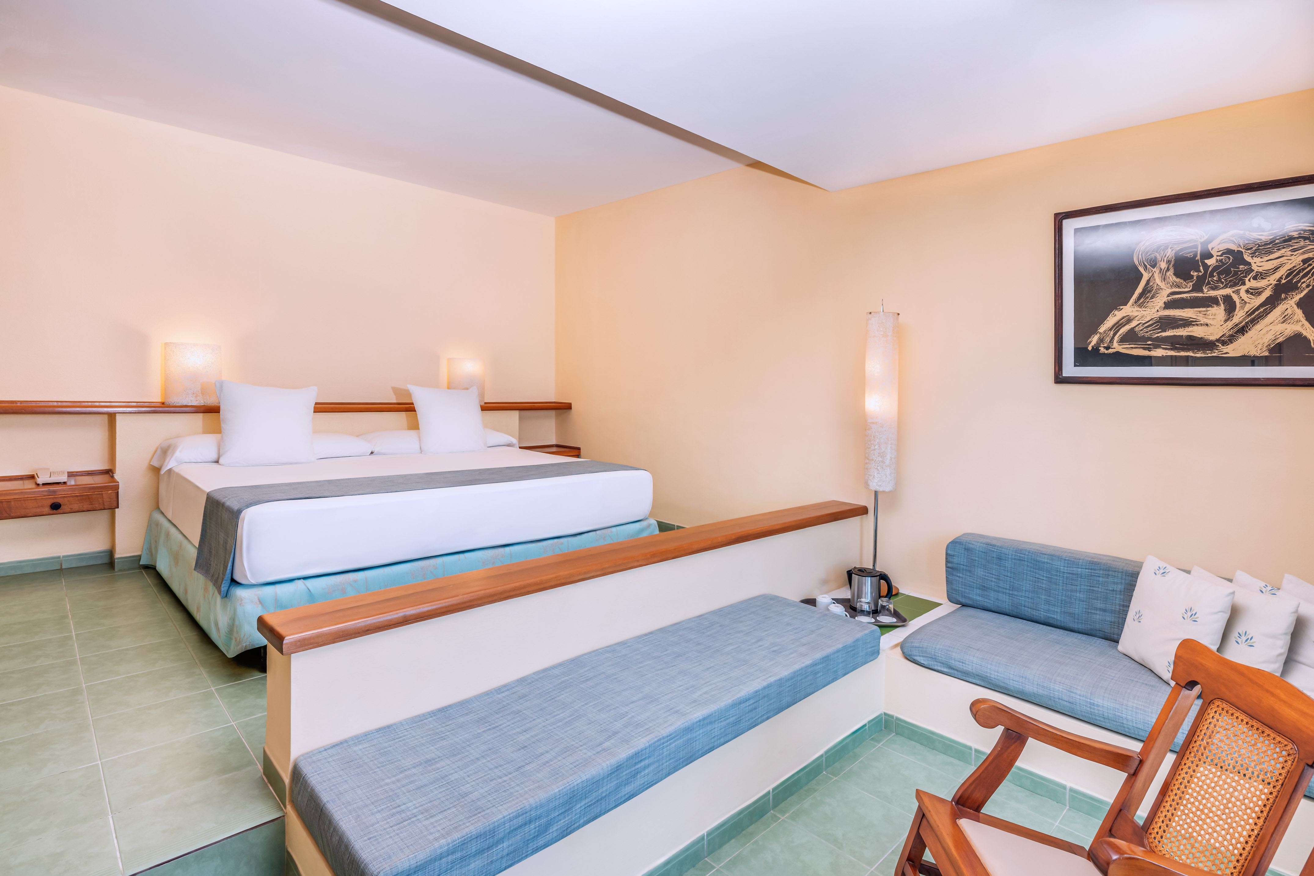 a room with two beds and a lamp