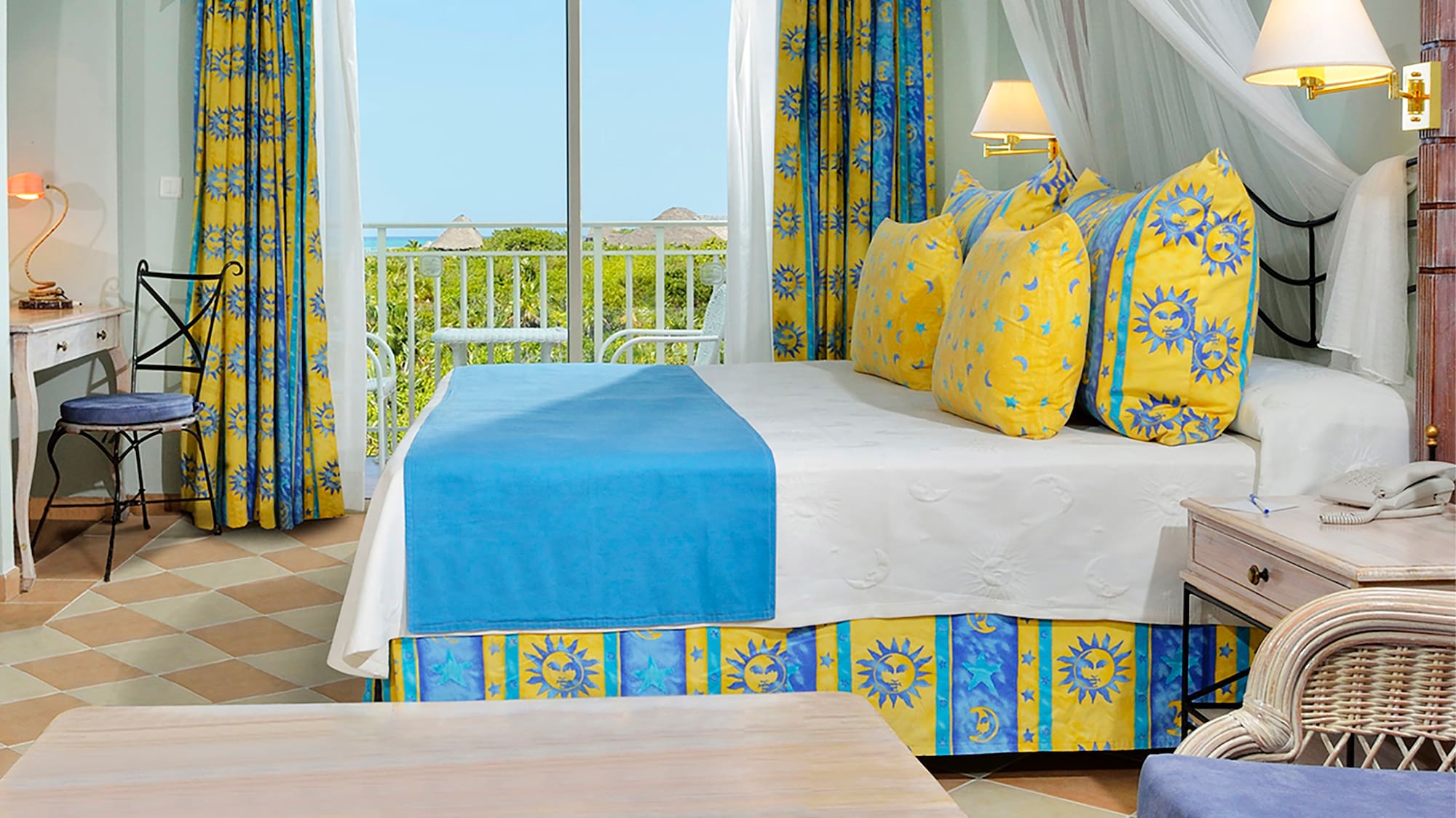 a room with a bed and chairs