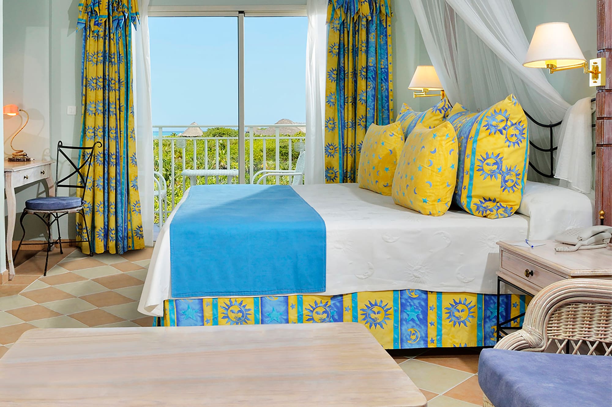 a room with a bed and chairs