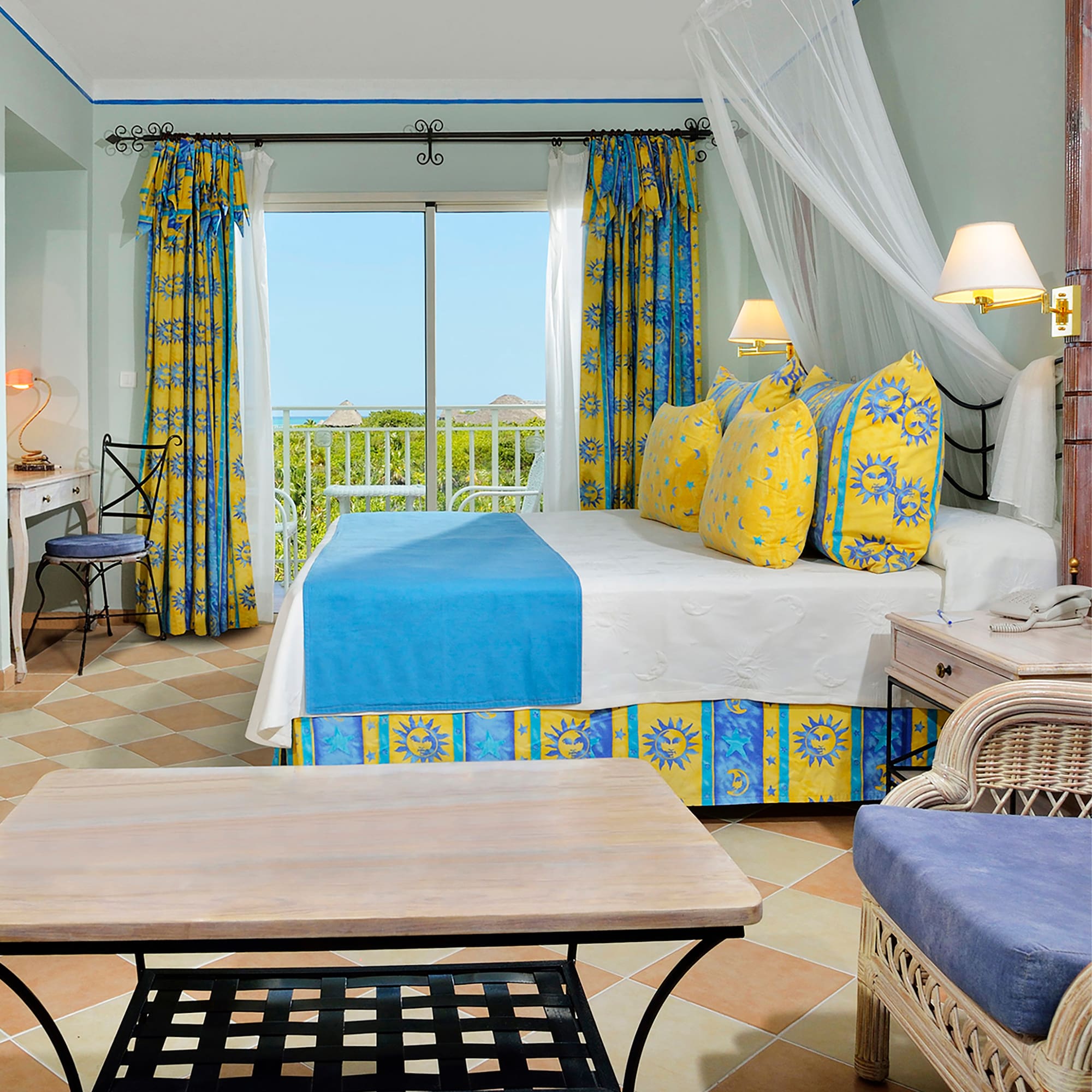 a room with a bed and chairs